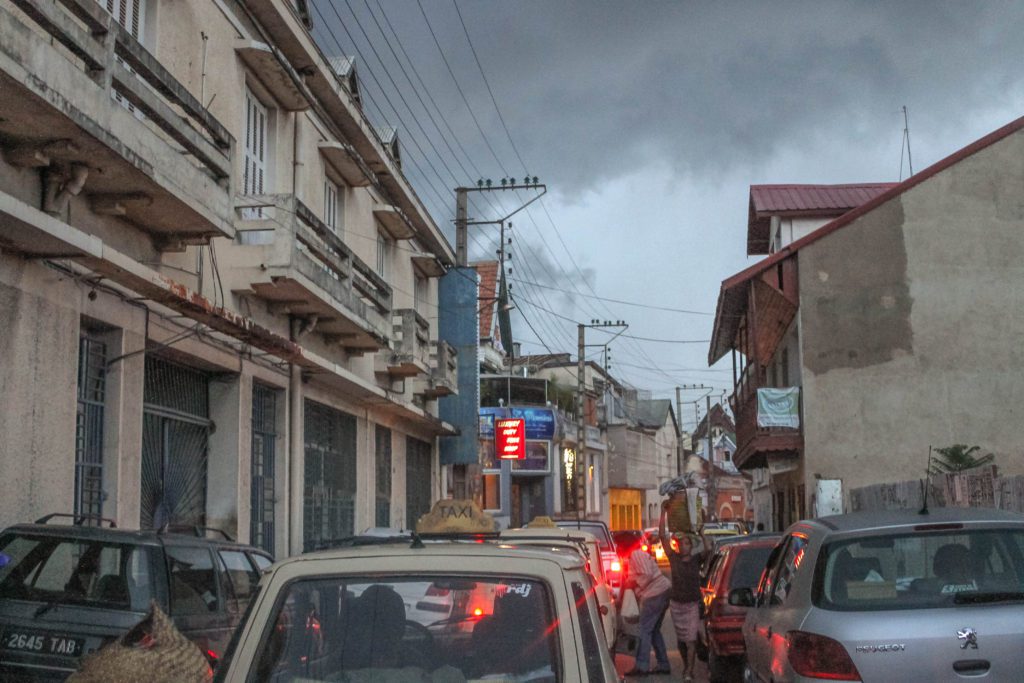 Traffic jam of taxis and cars in Antananarivo Madagascar with storm clouds above