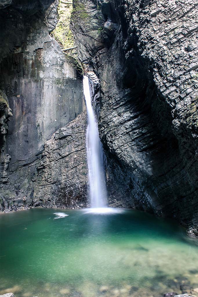 Kozjak waterfall is found at the end of a short hike near the town of Kobarid, Slovenia. This waterfall is known for being in a small canyon and having crystal clear water below it. 