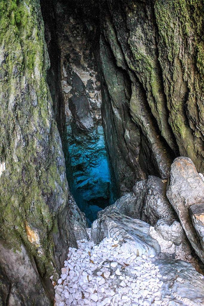 Hiking to the source of the Soca River will take you to this small cave where you can see the very clear water of the source of the river. 