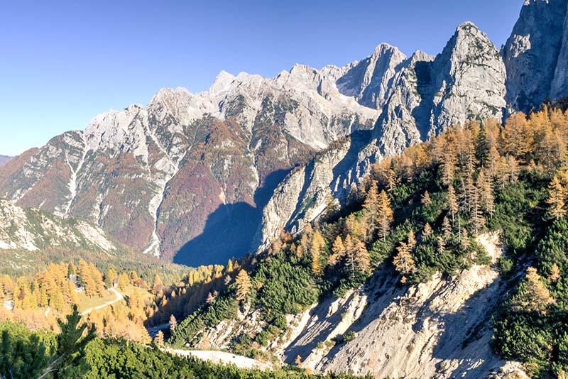 Slovenia's Julian Alps makes for a breathtaking road trip through the mountains of Europe. This is easily a travel highlight of Europe and great for an outdoor adventure. These mountains are right before the famous Vrsic Pass that go through the Julian Alps of Slovenia.