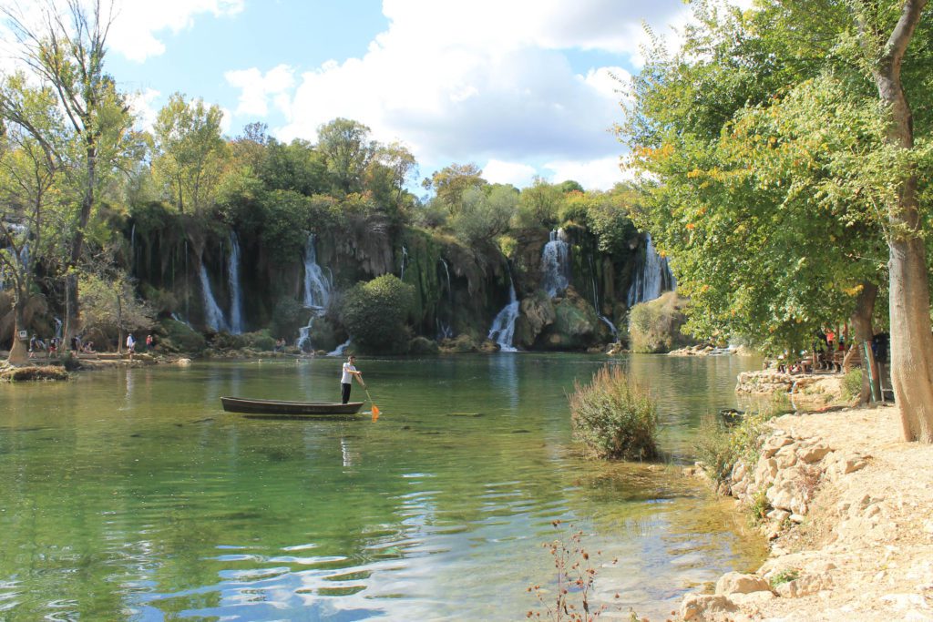 A gondola like boat ride across the lake at Kravice Waterfalls Bosnia