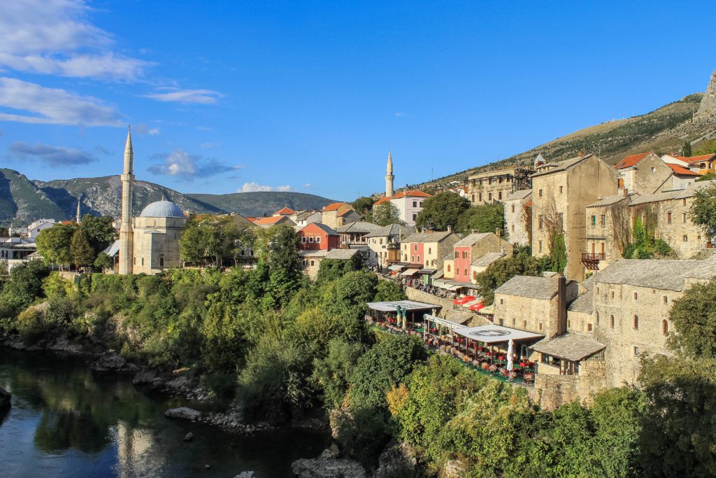 View of the Neretva River and Koski Mehmed Pasha Mosque from Stari Most Bosnia & Herzegovina. The bridge in Mostar is the highlight of visiting the town.
