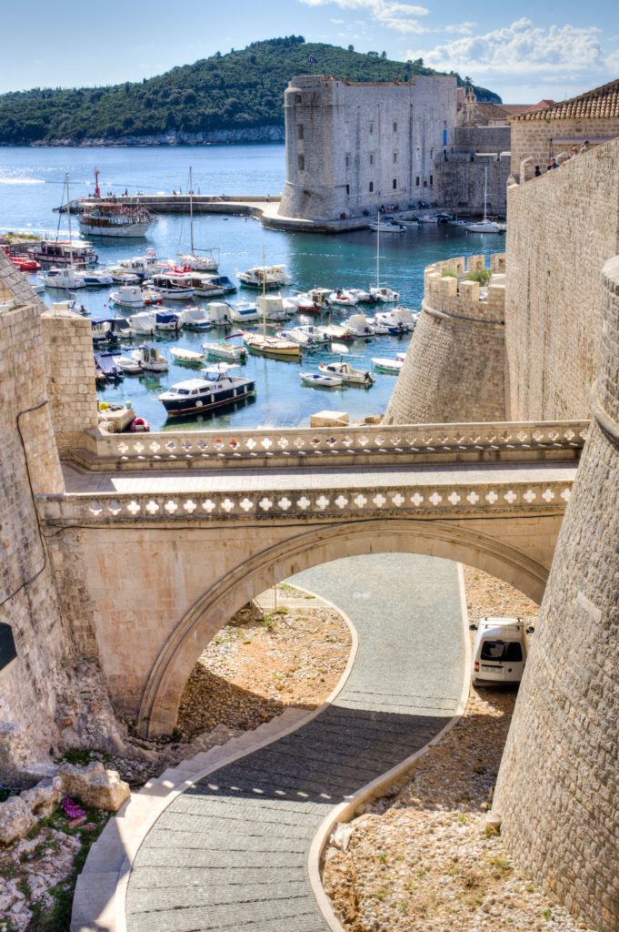 The harbor of Dubrovnik with the walls and bridge. Dubrovnik should be on everyones travel bucket list as it is one of the most beautiful cities in Europe with lots to offer ever visitor. You can stroll the streets of the old town and take in the sights of the Mediterranean sea. 