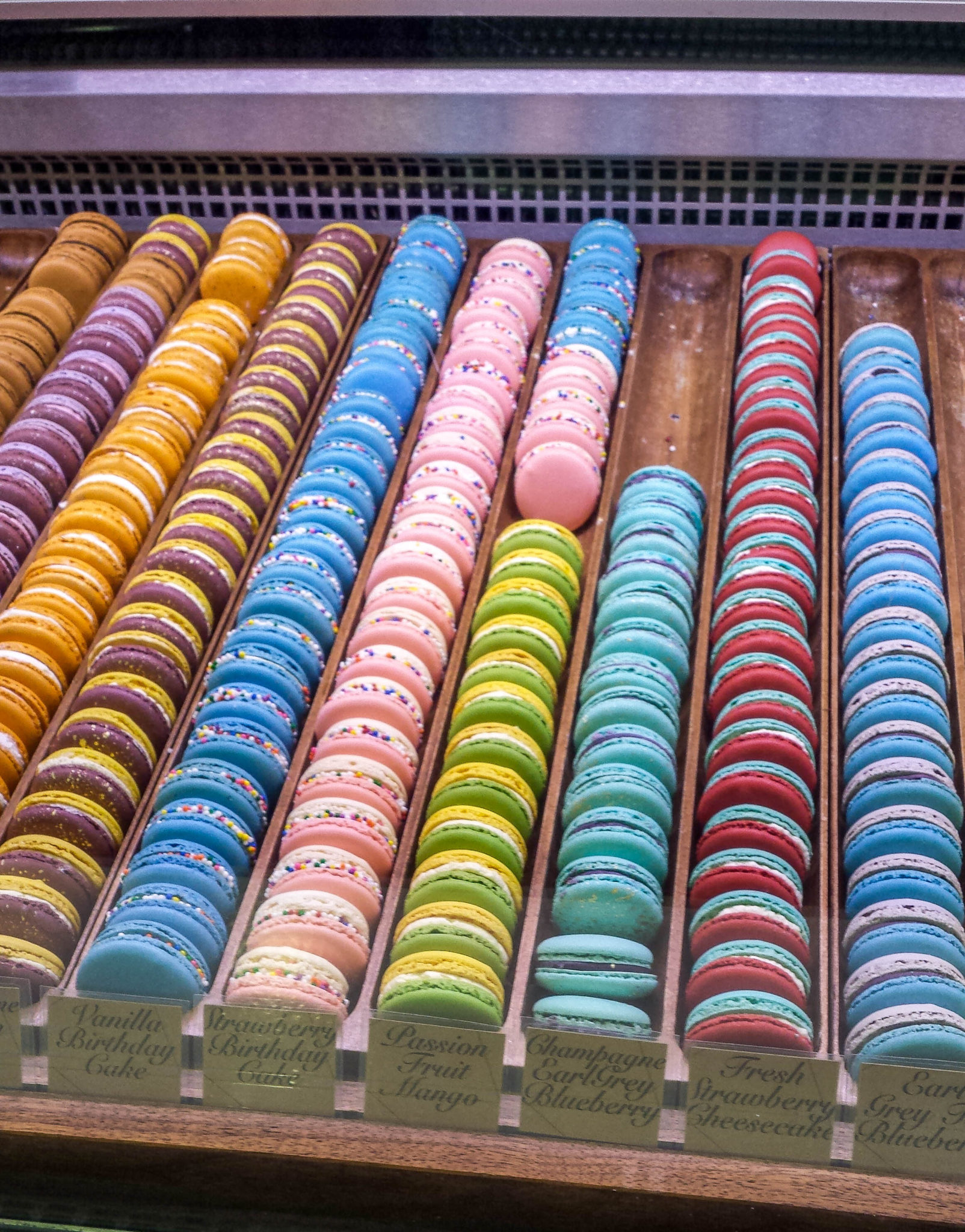 Multiple colours of macarons on display at Delysees Toronto