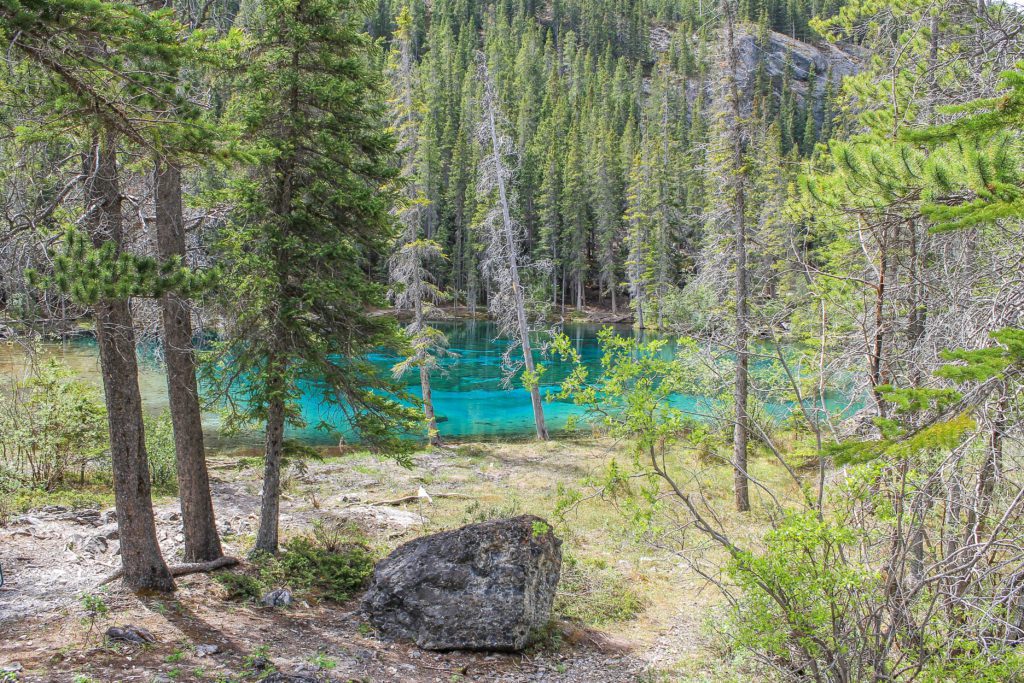 Grassi Lakes in the Rocky Mountains near Canmore, Alberta makes for a fantastic short hike accessible to all skill levels. The trail leads you up a rocky trail with views of the surrounding mountains and the reservoir below. There is a waterfall on the hike and at the top of the hike, two clear turquoise lakes. #canada #alberta #hiking #grassilakes #rockymountains