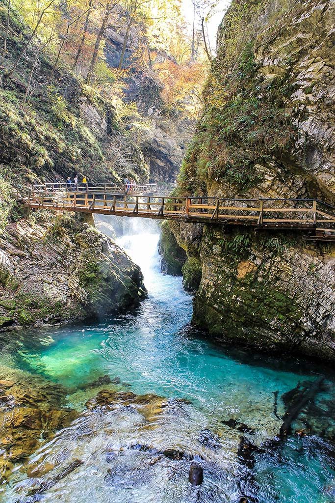Boardwalk through Vintgar gorge with teal water below. This is one of the best sights near Lake Bled and in Triglav National Park, Slovenia