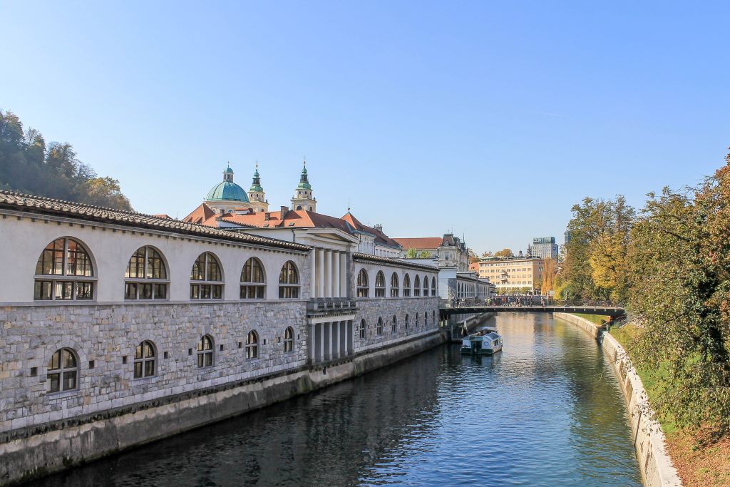 The river running through Ljubljana, Slovenia with buildings on one side of the river.