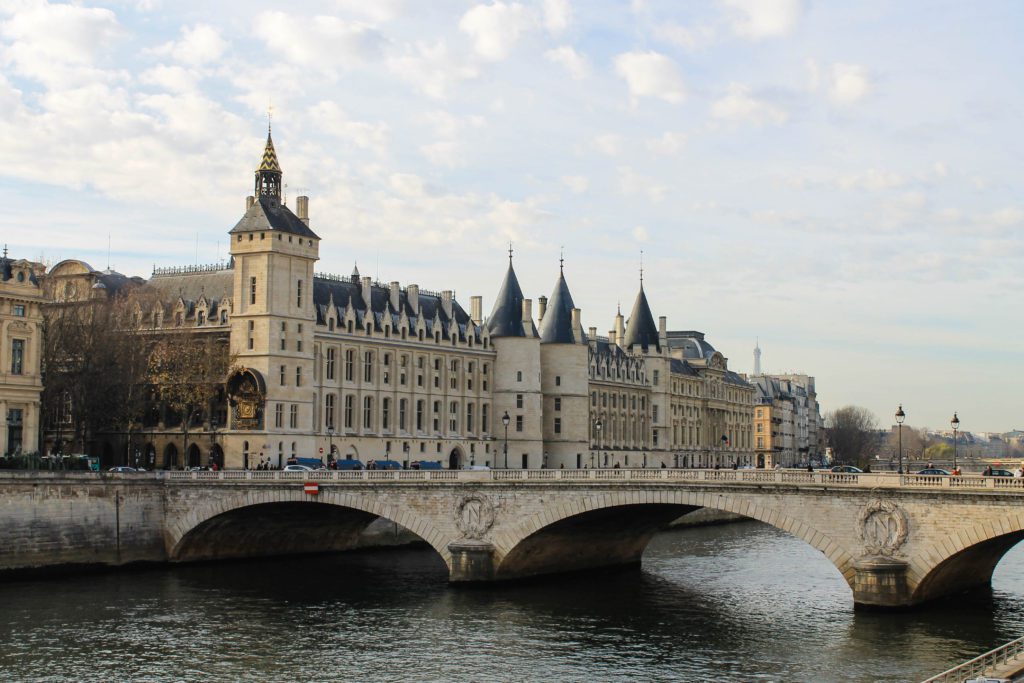 Bridge over the Seine river in Paris France and exterior of Conciergerie