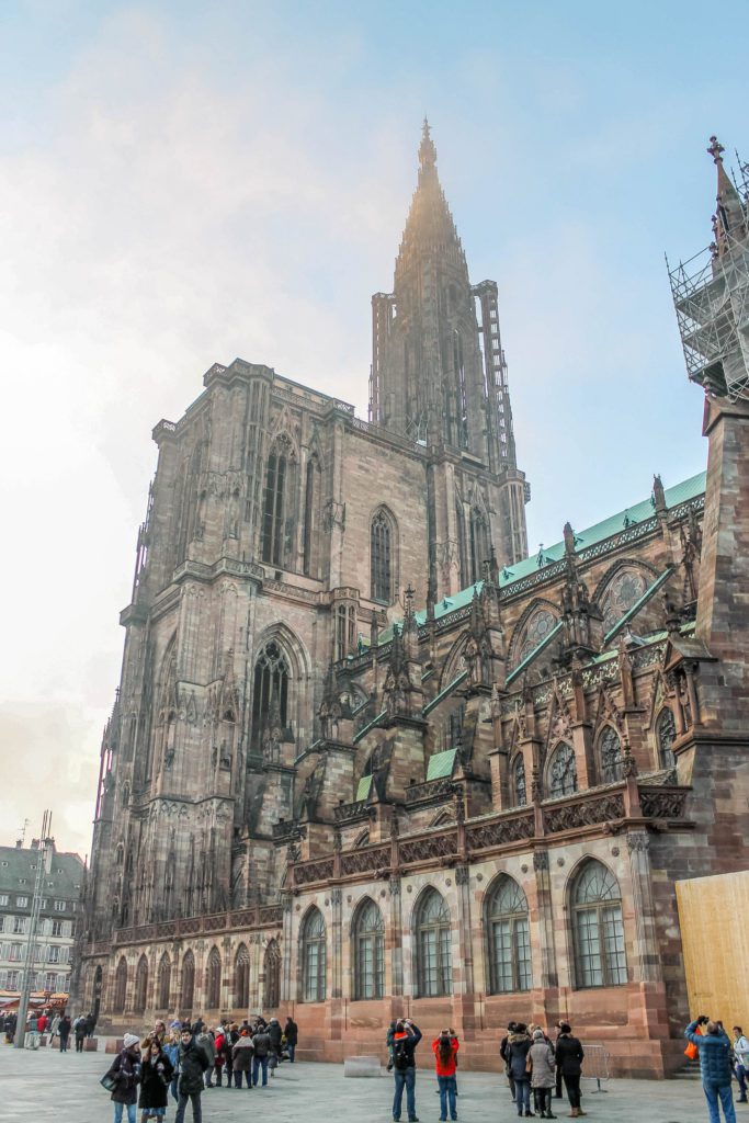 Side view of the gothic Strasbourg Cathedral with smoke covering the steeple