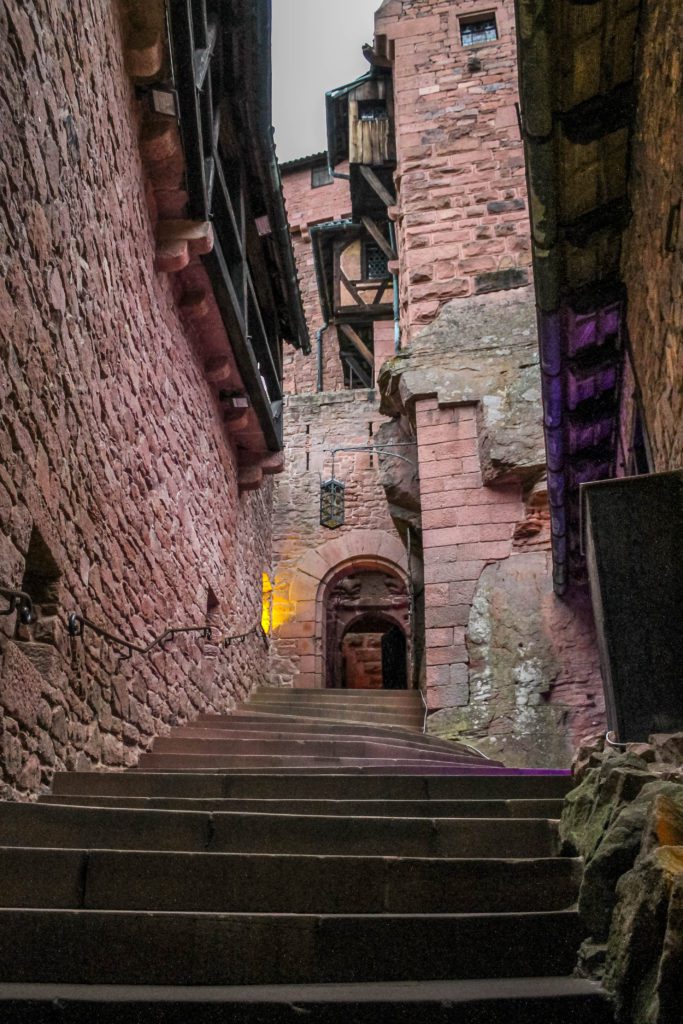 Interior of Haut-Koenigsbourg castle. Sandstone walls on either side of a staircase. Alsace France