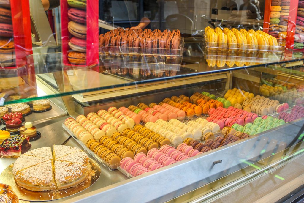 Multiple colors of macarons in a pastry shop window, Paris France