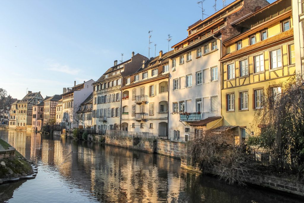 Canal on the Rhine River with Half-timbered houses lining it in Strasbourg, France is a great addition to any France itinerary and is easy to include if you have one week in France as it is very accessible from Paris.