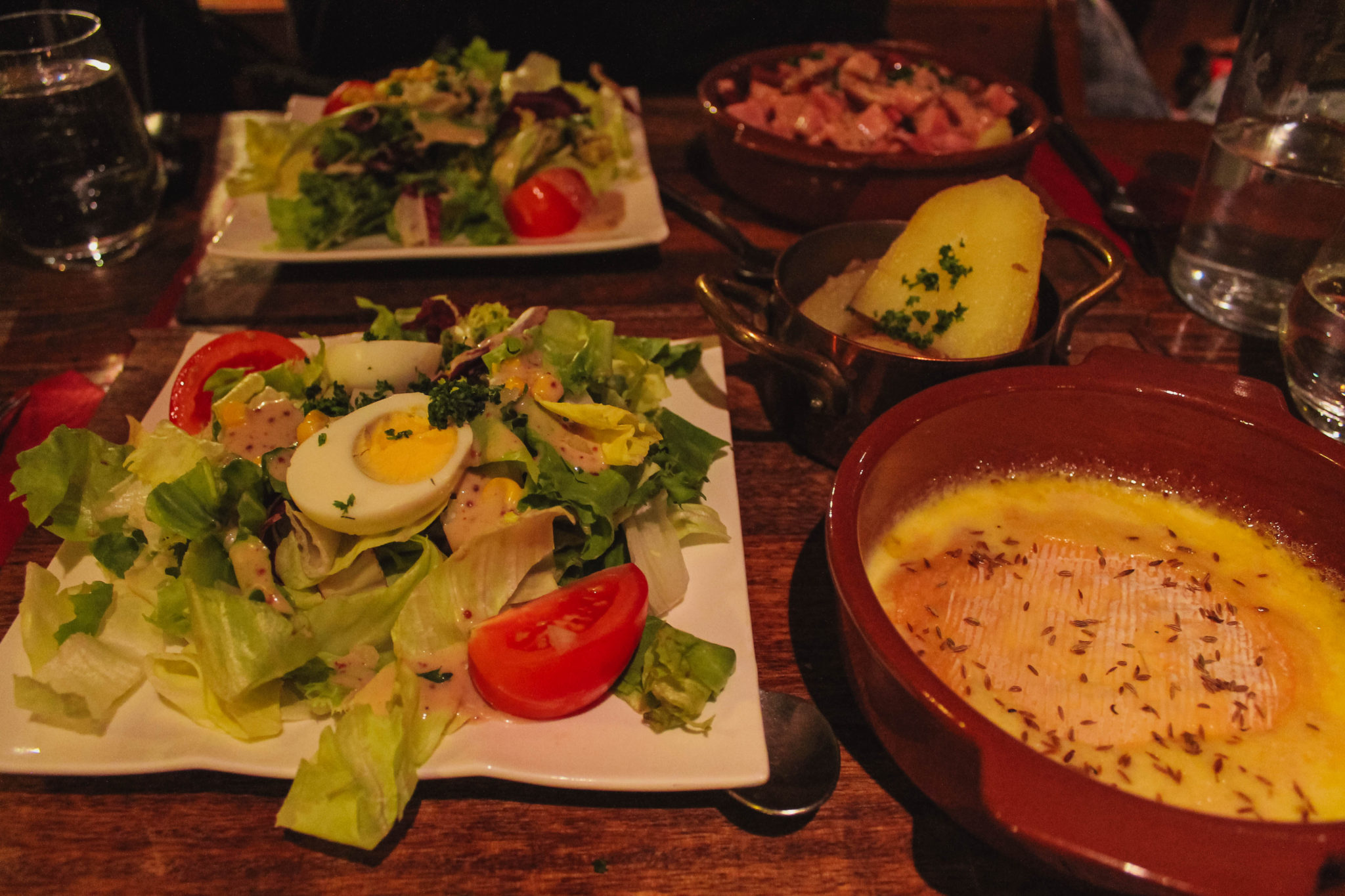 Traditional Alsatian food of a melted cheese and a salad in Colmar France