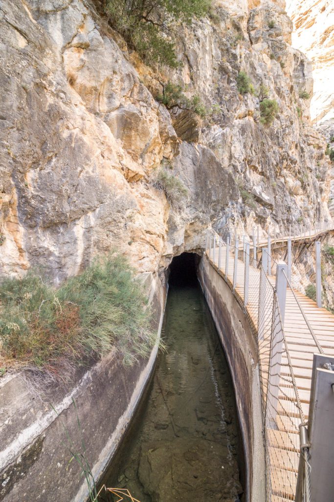 A channel of water from the El Chorro dam that runs through the Caminito del Rey hiking trail in Spain