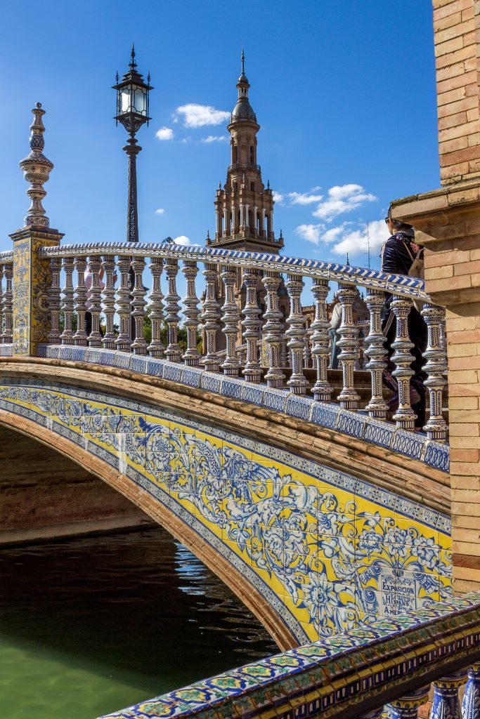Close up of the yellow, blue, and white tiling of the bridges in the Plaza de Espana.