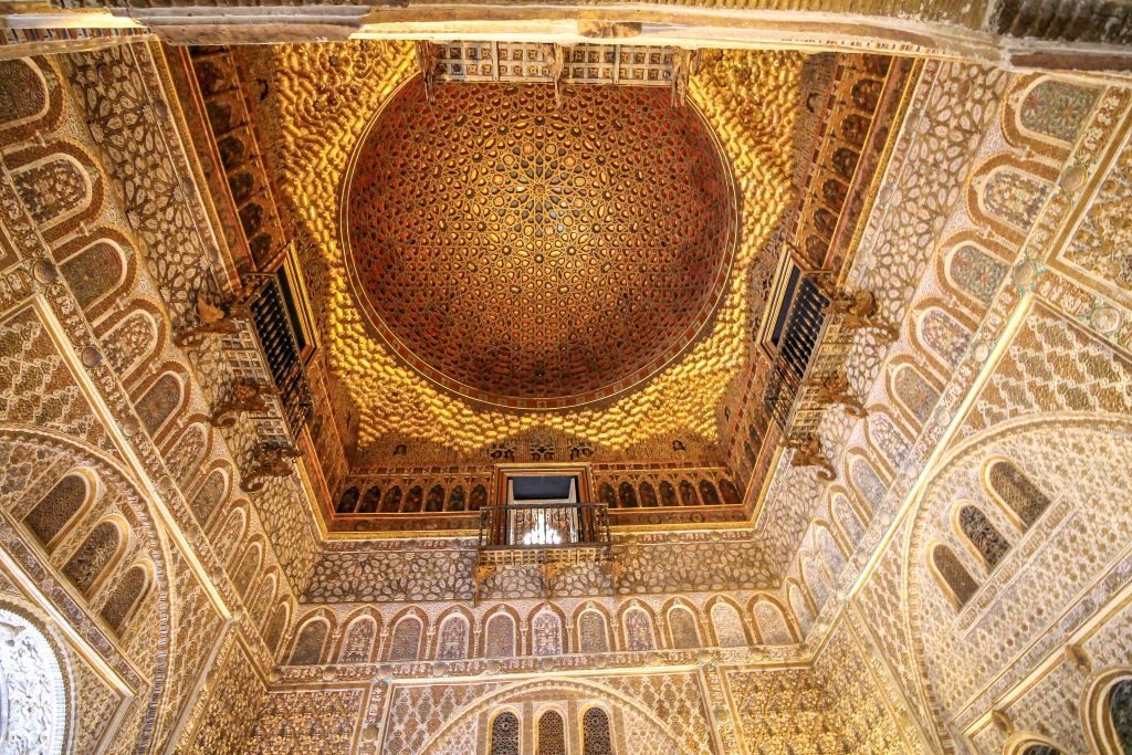 Gold tile ceiling domed and shaped to look like the sun. This gorgeous ceiling can be seen in the Real Alcazar of Seville, Spain