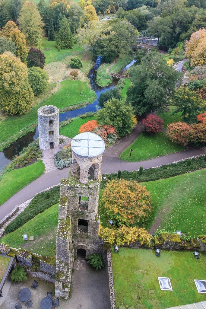 View from top of Blarney Castle of the tower and changing color of trees for autumn below