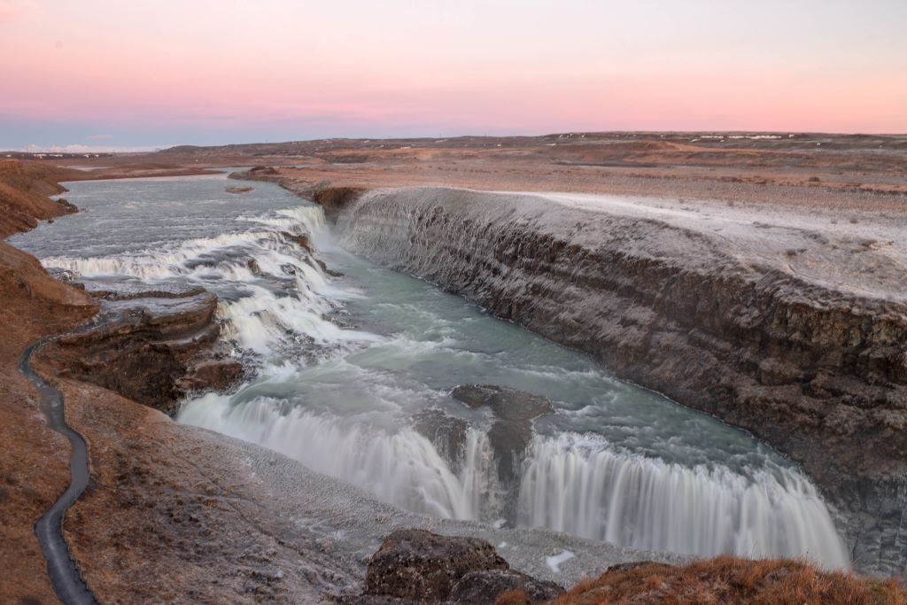 Gullfoss waterfall on Iceland's Golden Circle route as the sunsets. In winter Gullfoss cause everything around it to be covered in a thick layer of ice.