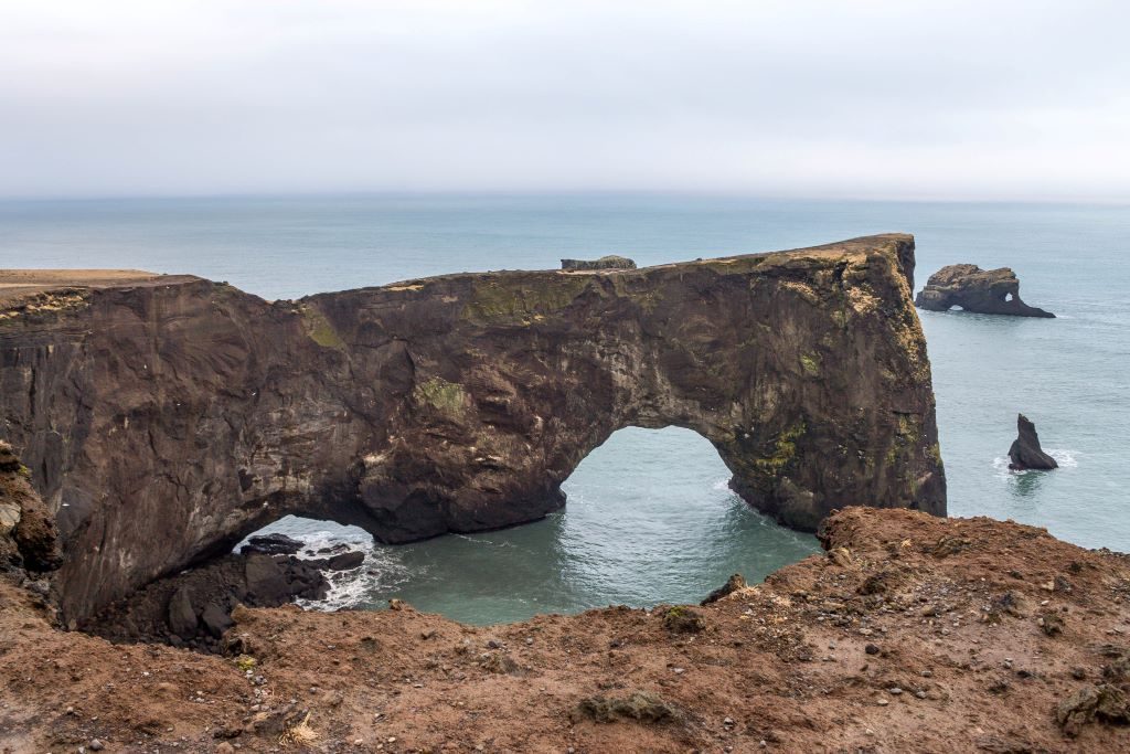 Dyrholaey arch near the lighthouse and Vik, Iceland. In summertime there are puffins that nest on the cliffs here.