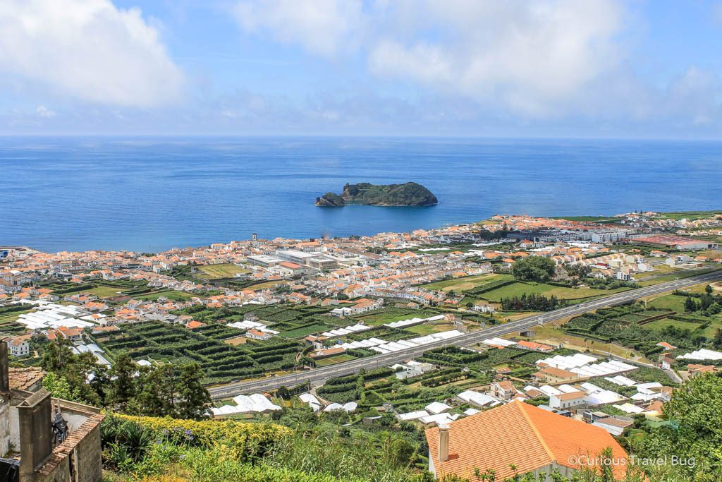 View of Vila Franco do Campo from Nossa Senhora da Paz or Our Lady of Peace Chapel on Sao Miguel in the Azores. This chapel is one of the most beautiful chapels in the Azores and offers up a stunning view of the town below and volcanic islet nearby.