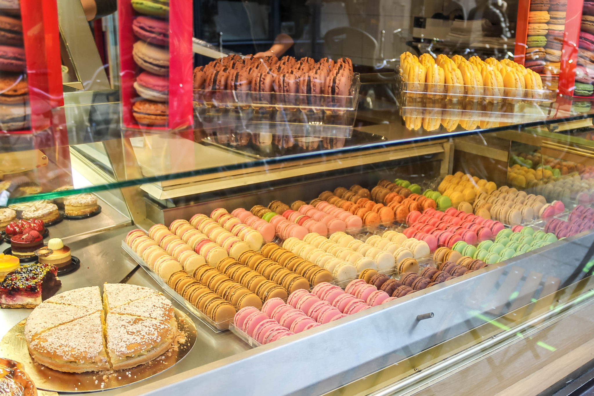 Display of macarons and pastries in Paris, France. Paris has some of the best French desserts in the world. With everything from caramels to macarons and eclairs, don't miss these top dessert spots in Paris on your visit to the city.