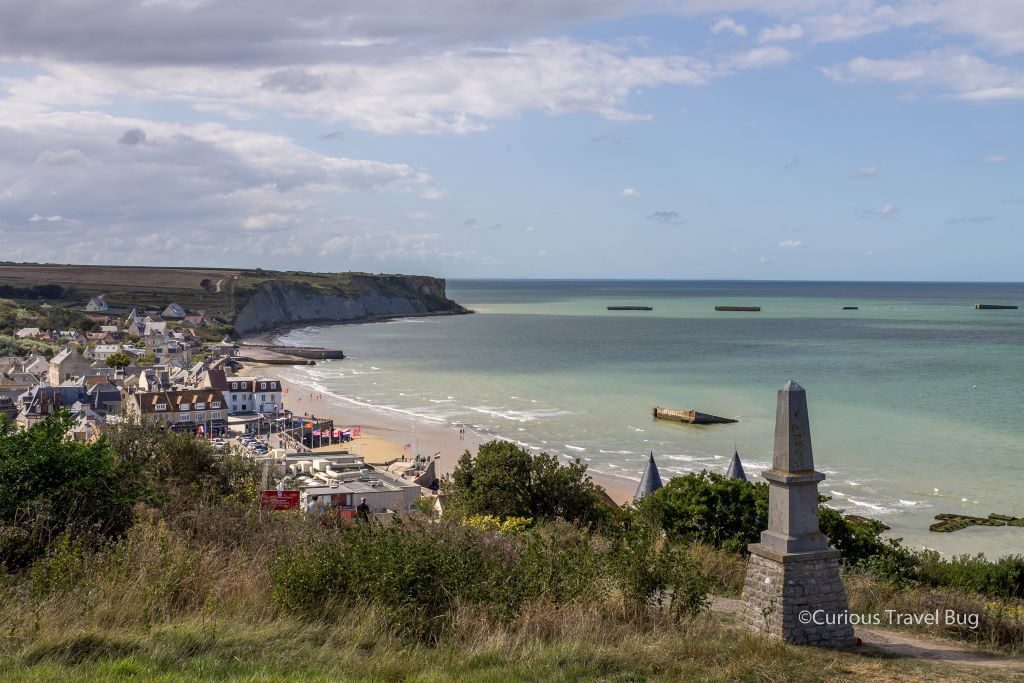 This D-Day site is Arromanches. It overlooks the Gold Beach and the remains of the artificial port installed during the invasion of Normandy