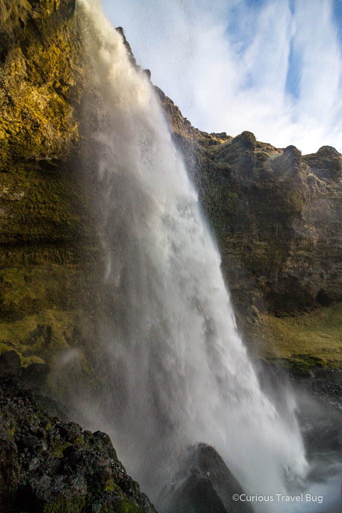 Walking behind a hidden waterfall on Iceland's south coast near the Ring Road