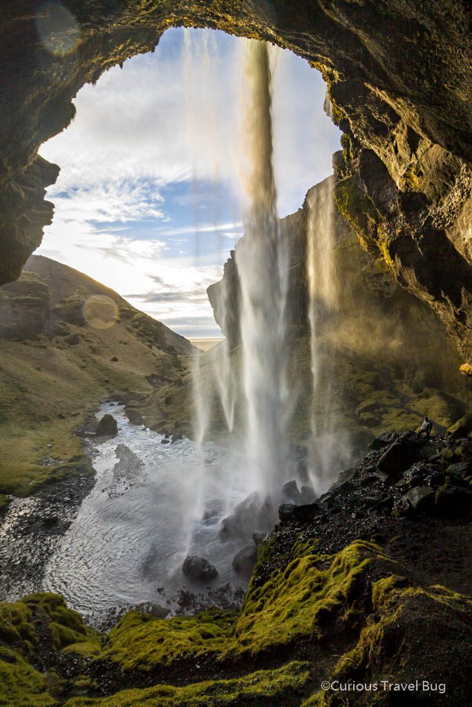 The view from behind the waterfall in Iceland. Kvernufoss is a great waterfall to visit on the south coast of Iceland just off the Ring Road.