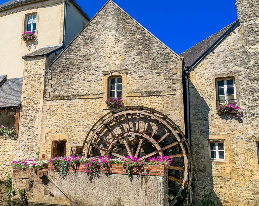 The waterwheel in Bayeux, France. Bayeux is the perfect city in France to visit the D-day Beaches from as well as taste some of the delicious foods of Normandy and tour the medieval city.
