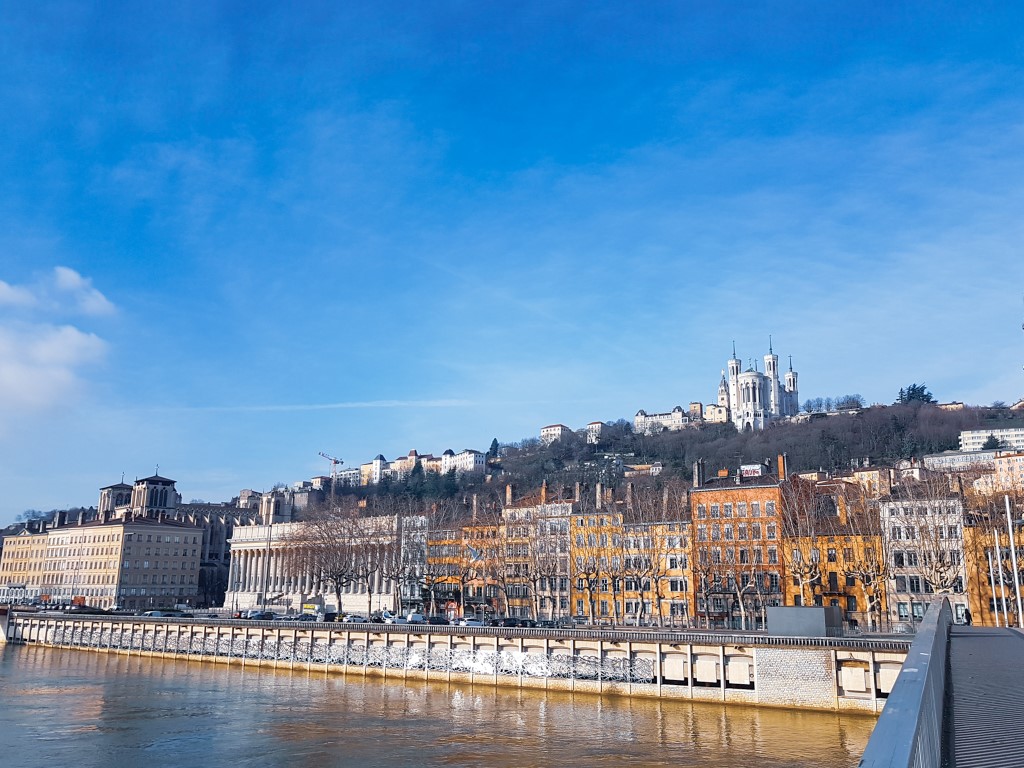 The city of Lyon in France from the river. Lyon is one of France's largest cities and is known as the gastronomy capital of France. This charming city has an interesting history with secret passageways around the old town for silk workers to use. It's one of the best cities to visit in France if you're a foodie.