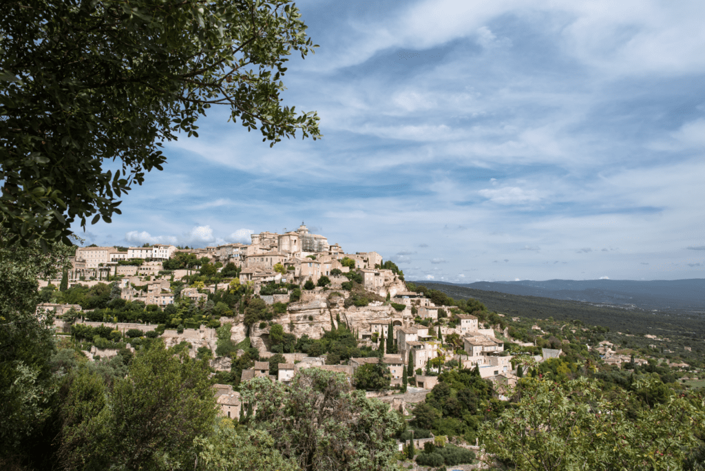 Gordes is one of the best towns in France to visit because it is one of the best hilltop town in Provence and is full of delicious food and beautiful architecture. Pictured here is the chateau in Gordes and the town that spreads out below it. 