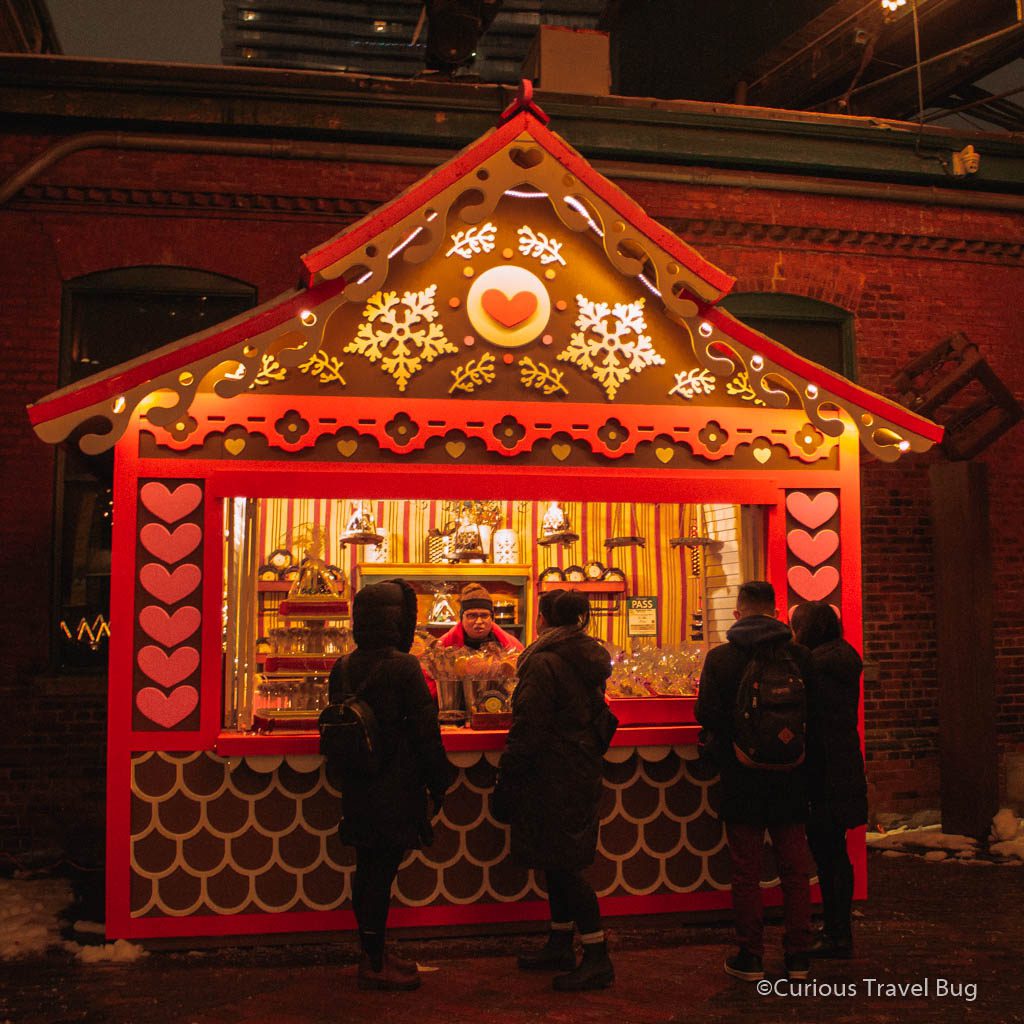A stall made to look like gingerbread, selling gingerbread at the Toronto Christmas Market in the Distillery District. This is a massively popular market that is often quite busy on the weekends.