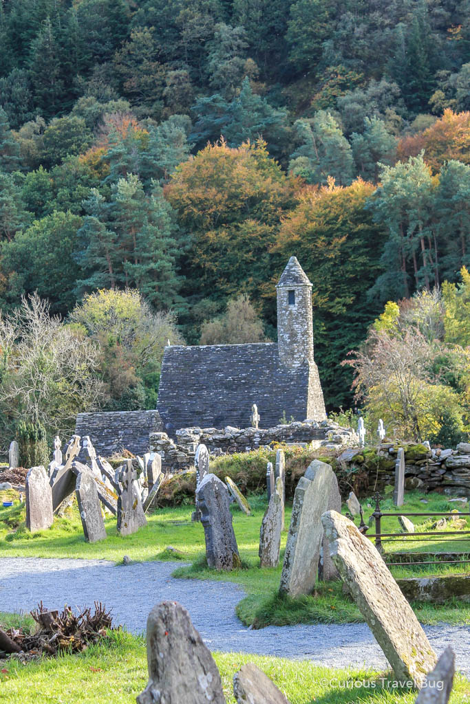 Some of the ruins and grave markers at Glendalough in Ireland. A Wicklow Glendalough tour is the perfect way to experience this site.