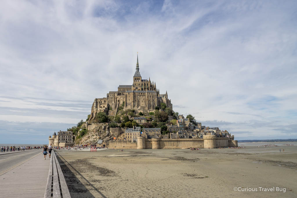 Mont Saint Michel in Normandy France during the day at low tide. This is one of the most visited sites in France and a must visit if you are in Brittany or the Normandy region.