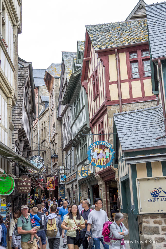 The crowded streets of Mont Saint Michel during the day time