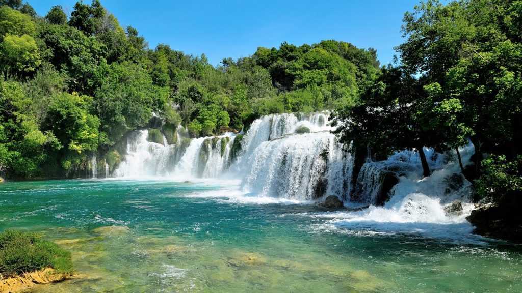 Krka National Park in Croatia has one of the most beautiful, tropical looking waterfalls in Europe. The best part is that you can swim under this waterfall. It's only a short distance from Split so its a great day trip when visiting Croatia.