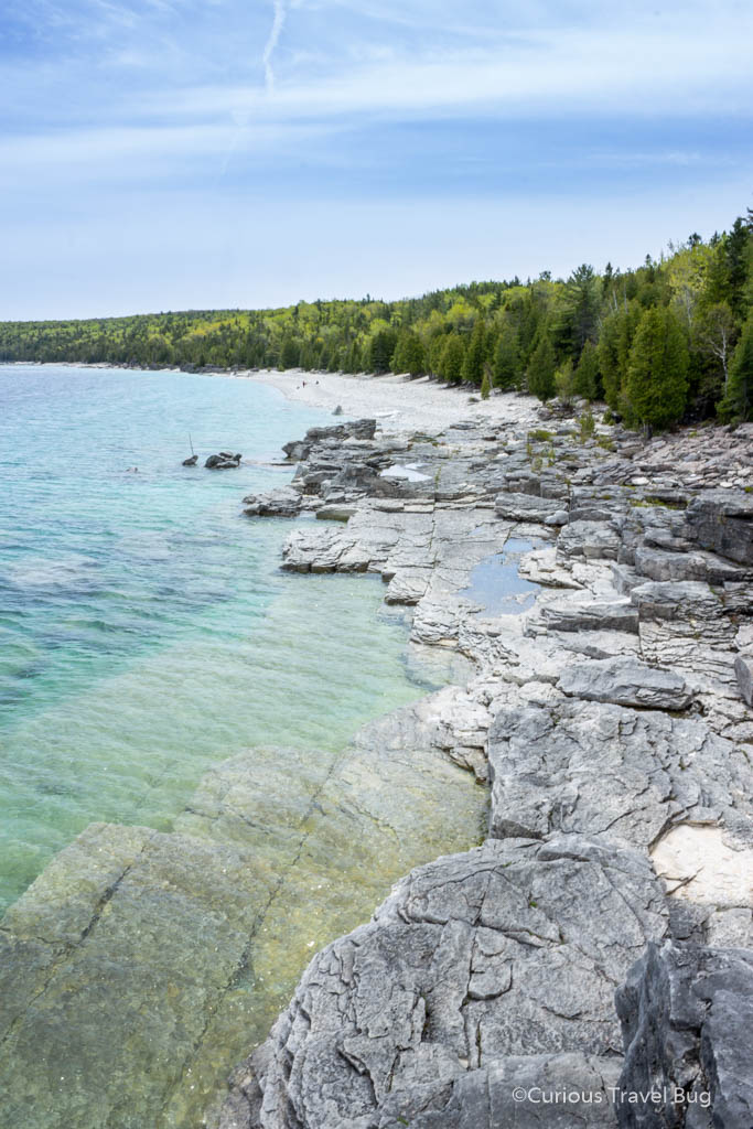 View from the scenic outlook at Halfway Log Dump in Bruce Peninsula. Located on the shores of Georgian Bay, this beach has crystal clear water and bouldering sites for any climbers.