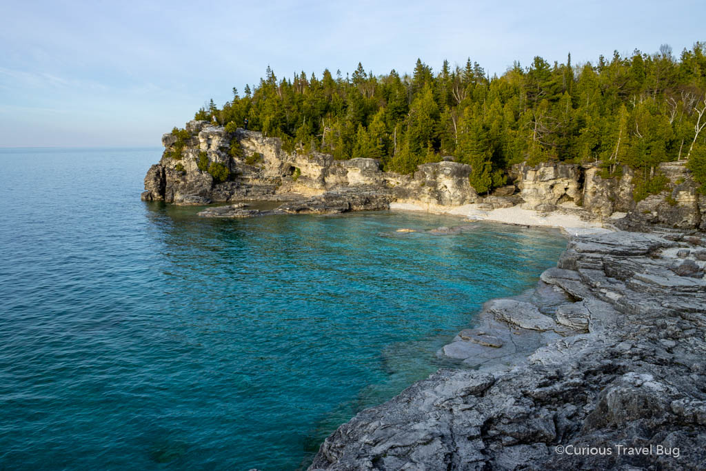 Indian Head Cove is one of the most scenic coves at Bruce Peninsula near Tobermory, Ontario. This cove has cold blue water that looks more tropical than the water temperature and cedar and pine trees would suggest.