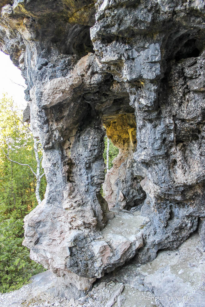 Trail and small cave on Flowerport Island near Tobermory, Ontario, Canada. This rocky trail offers scenic outlooks over Lake Huron.