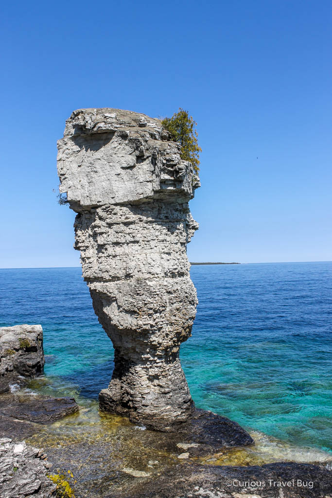 A rock pillar that looks like a flowerpot on Flowerpot Island near Tobermory, Ontario, Canada. A visit to Flowerpot Island is one of the most popular things to do when visiting the Bruce Peninsula