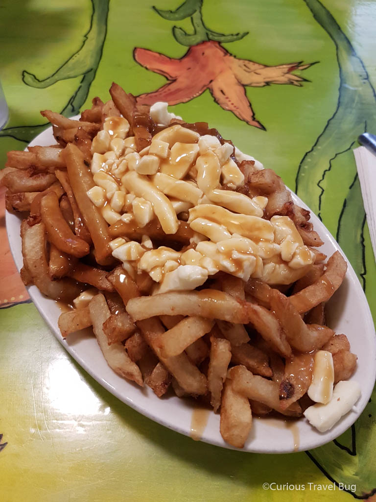 Classic Poutine from La Banquise in Montreal. Poutine is a classic Quebec and Montreal food that you should try when you visit the city. They even have vegan poutine at La Banquise!
