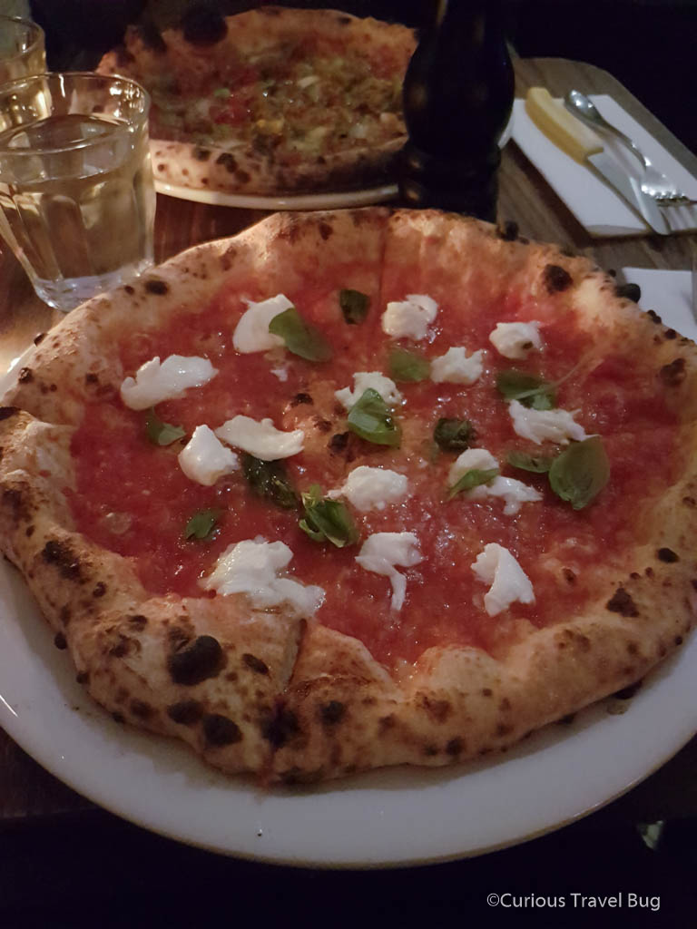 Margherita pizza from Pizza 900 in Montreal. This is the best pizza in downtown Montreal and a great option at the end of the day for a cozy atmosphere and delicious wood fired pizzas.