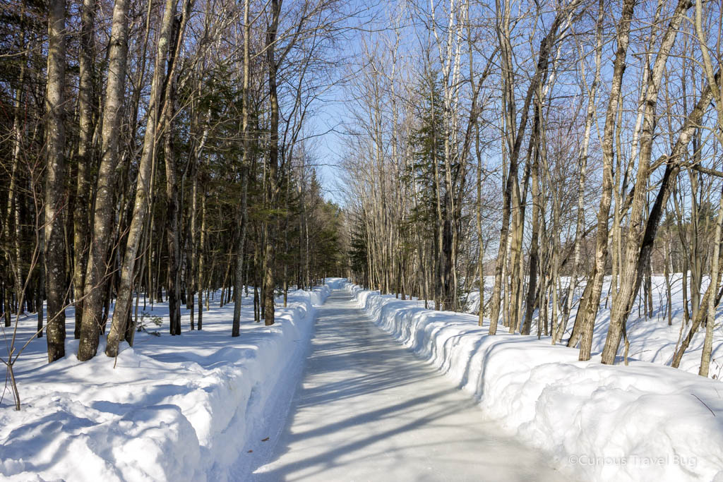 Forest skating trail in Quebec at Domaine Enchanteur. This 15km ice trail through the forest is a fun unique activity you can do in Quebec as a day trip from Montreal.