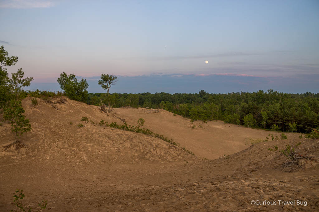 Purple sky and a full moon over the dunes at Sandbanks Provincial Park in Ontario. This is a great day trip destination and the dunes are perfect to walk at sunset when the weather is cooler.