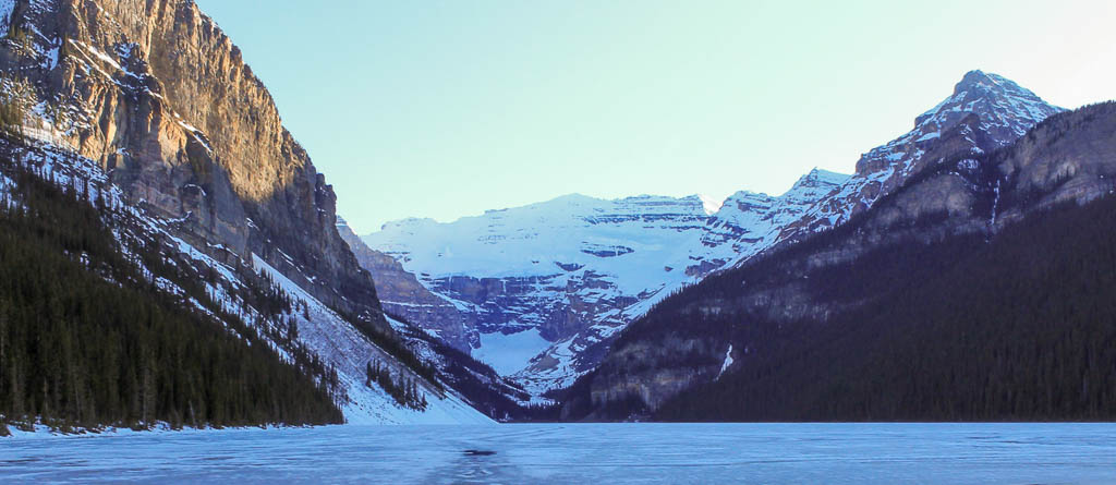 Frozen Lake Louise in Banff, Alberta. This is the ultimate bucket list item for any ice skater. The ice on Lake Louise is perfect for skating with a beautiful winter backdrop of snowy mountains.