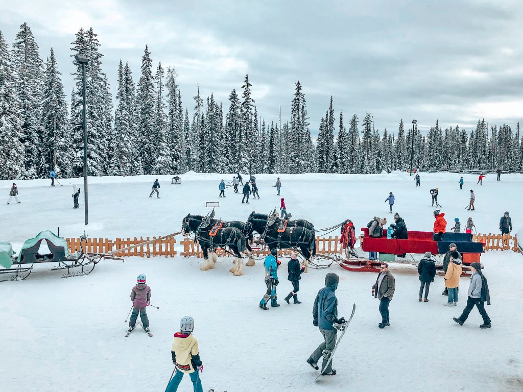 People skating and playing hockey at Big White Ski Resort in British Columbia, Canada. This is the highest skating rink in North America and has the benefit of being at an amazing resort with plenty of other activities.
