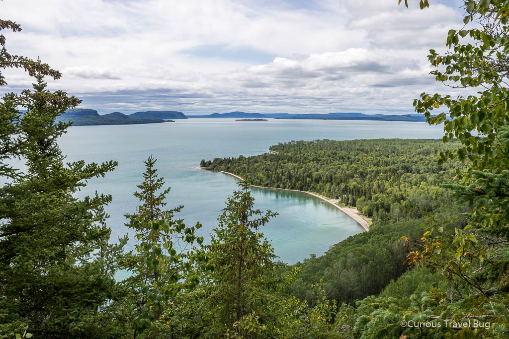 Lookout over Lake Superior with islands and teal water in Ontario.Kama Bay Lookout is one of the best spots to stop for a view when driving from Toronto to Thunder Bay on a road trip.