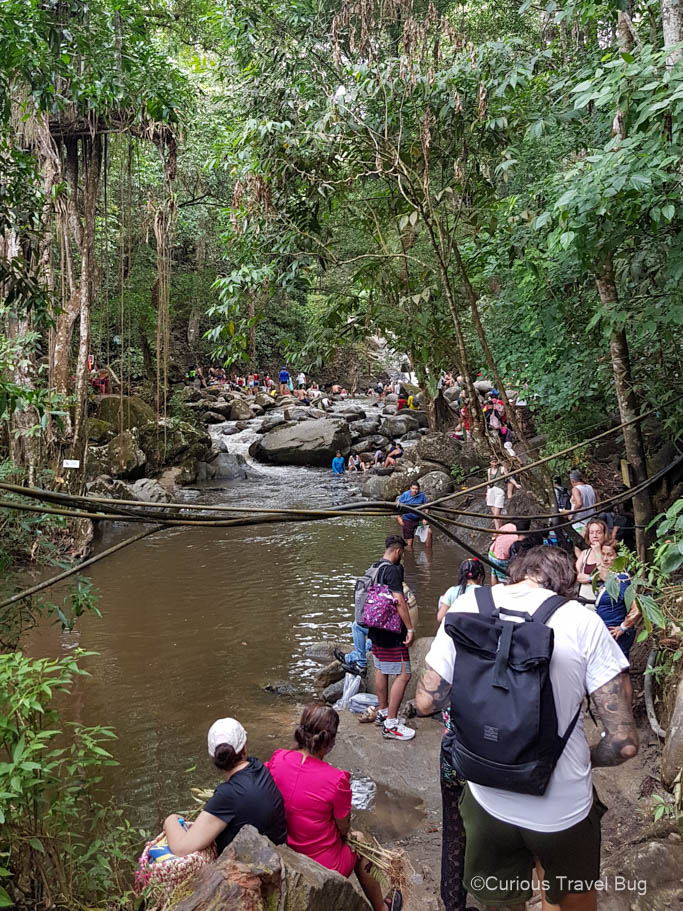 Crowded Pozo Azul waterfall near Minca, Colombia