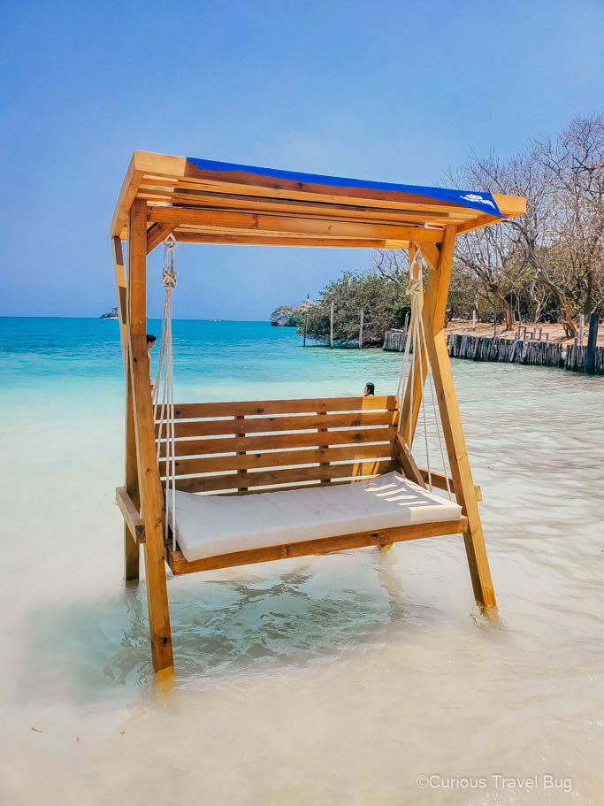 A swing in the teal Caribbean Sea in the Rosario Islands of Colombia. This is the best place to visit from Cartagena as a day trip. 