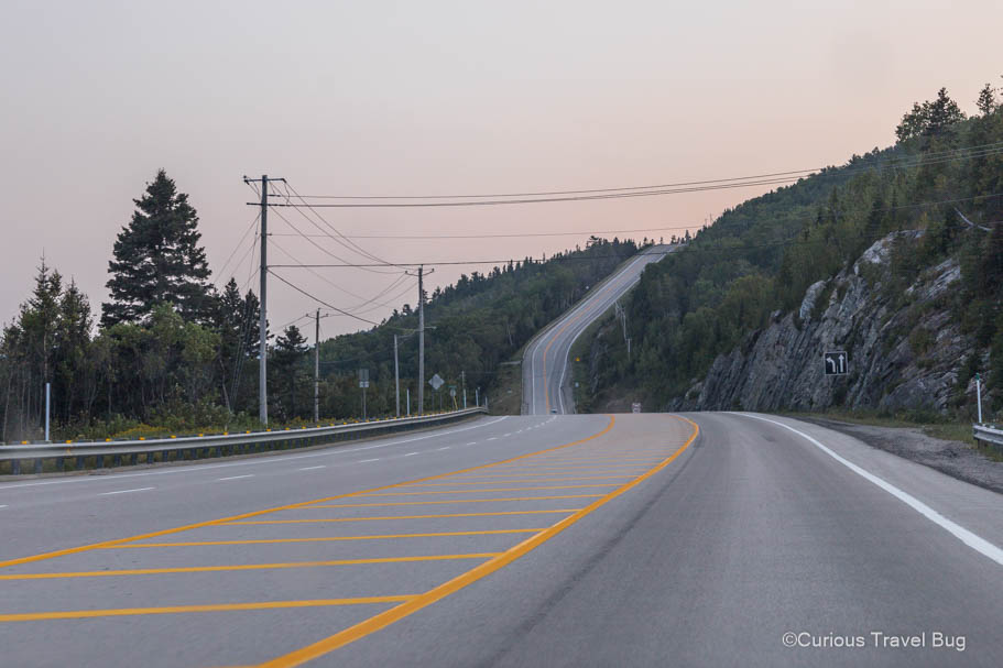 Sunset on the winding and hilly roads on the coast of Quebec, the perfect roads to travel on for a Quebec road trip